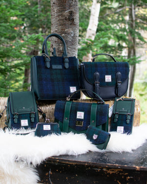 Collection of green and blue bags on a wooden surface with a natural background
